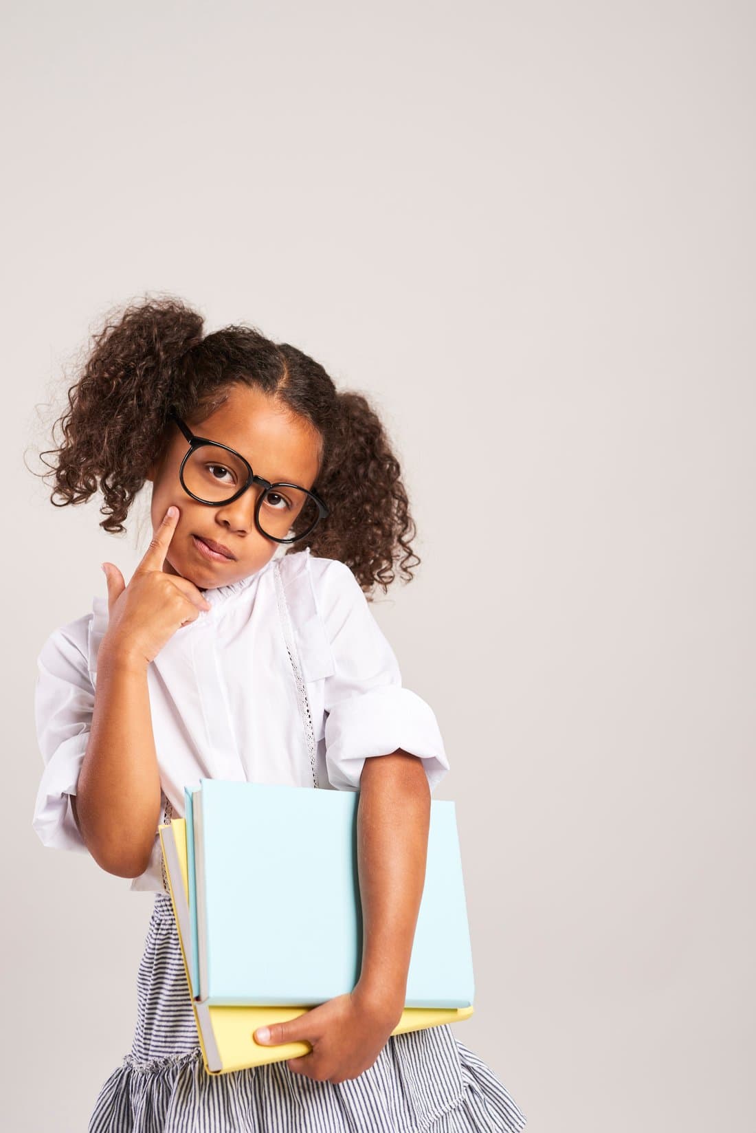 A thoughtful young student holding her school books